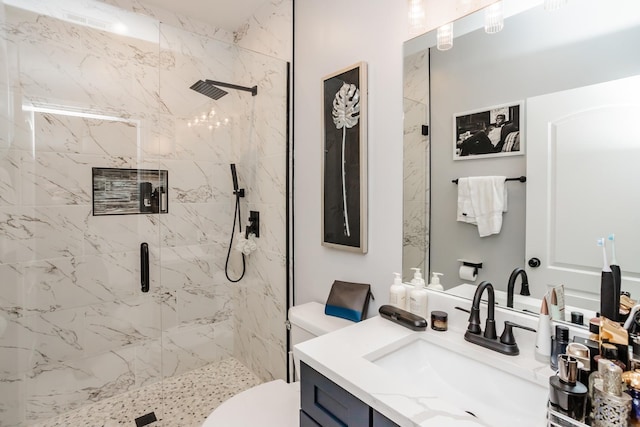 bathroom with vanity, an enclosed shower, and toilet