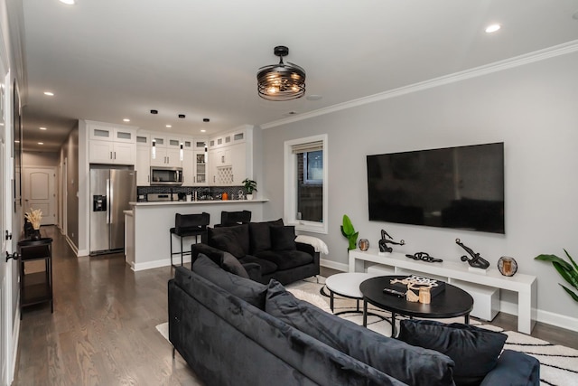 living room with dark hardwood / wood-style flooring and ornamental molding