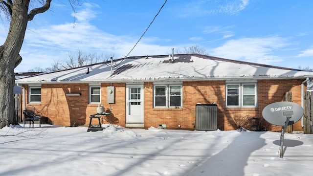 snow covered property featuring central AC