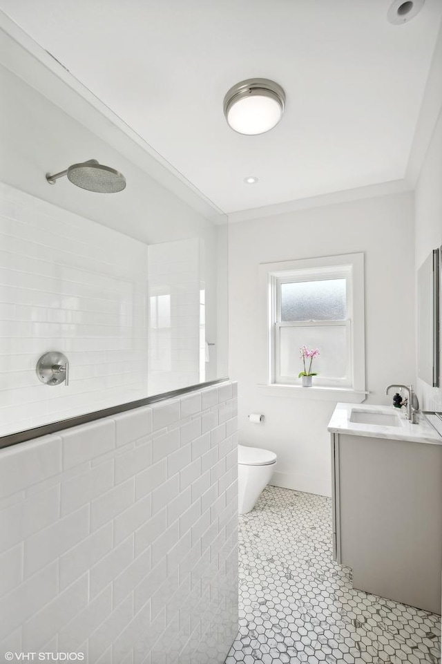 bathroom featuring tile patterned flooring, vanity, toilet, and walk in shower