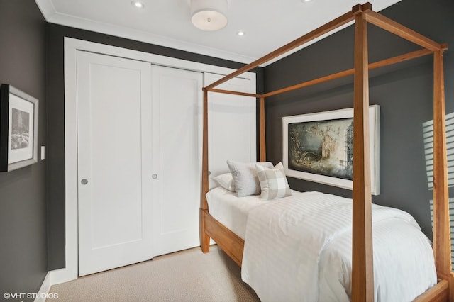 bedroom with light carpet, a closet, and ornamental molding