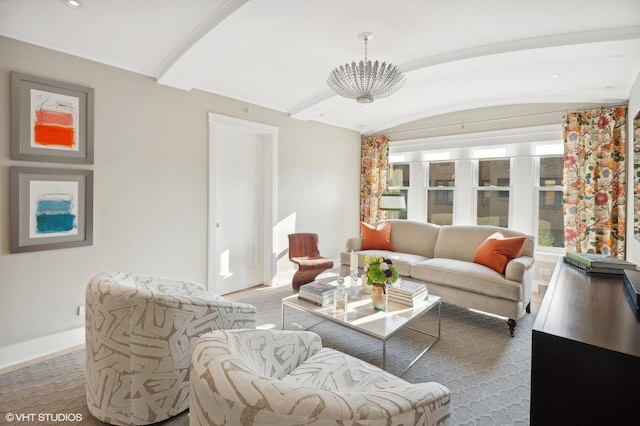 living room featuring lofted ceiling and a notable chandelier