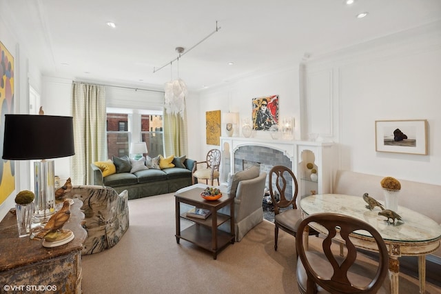 carpeted living room with a tile fireplace and ornamental molding