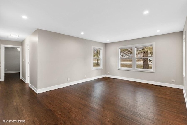 unfurnished room with dark hardwood / wood-style floors