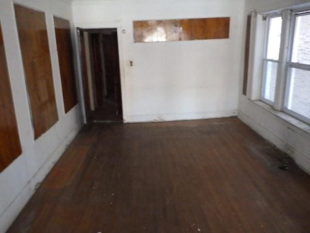 spare room featuring dark wood-type flooring