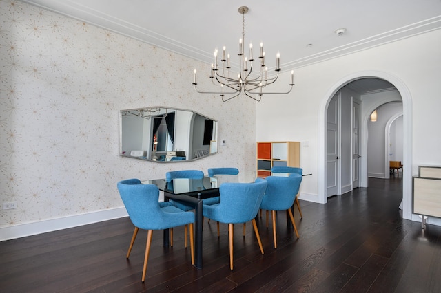 dining room featuring ornamental molding, dark wood-type flooring, and a chandelier