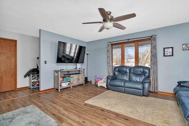 living room with ceiling fan and hardwood / wood-style flooring