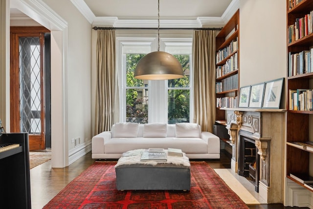 sitting room featuring dark hardwood / wood-style floors, built in features, and crown molding