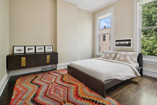 bedroom featuring ornamental molding and dark wood-type flooring