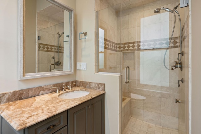 bathroom featuring vanity and a shower with door