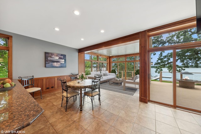 tiled dining area featuring a water view