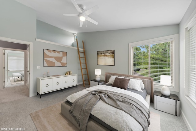 bedroom featuring ceiling fan, light colored carpet, multiple windows, and lofted ceiling