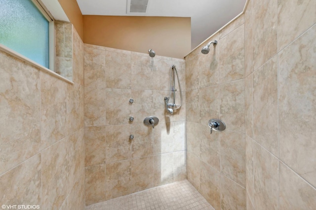 bathroom with a tile shower