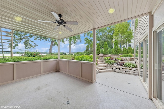 unfurnished sunroom featuring ceiling fan and wooden ceiling