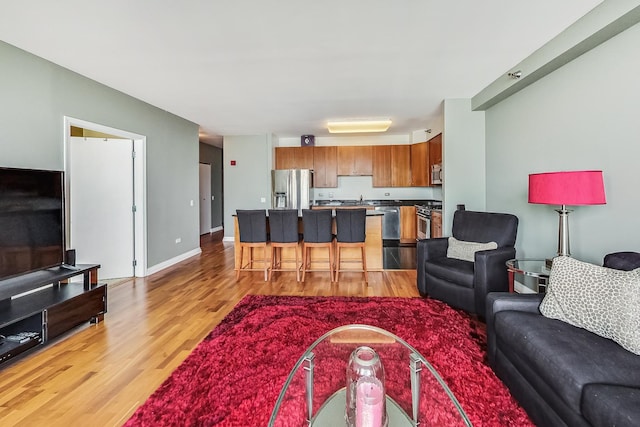 living room with light wood-type flooring and sink