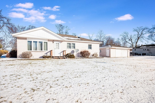 back of property featuring an outbuilding and a garage