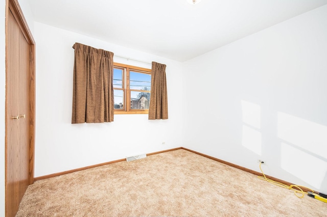 unfurnished room featuring carpet