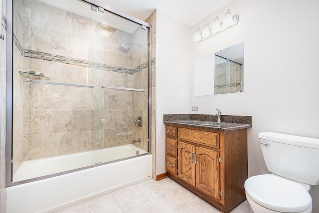 full bathroom with tile patterned flooring, vanity, toilet, and bath / shower combo with glass door