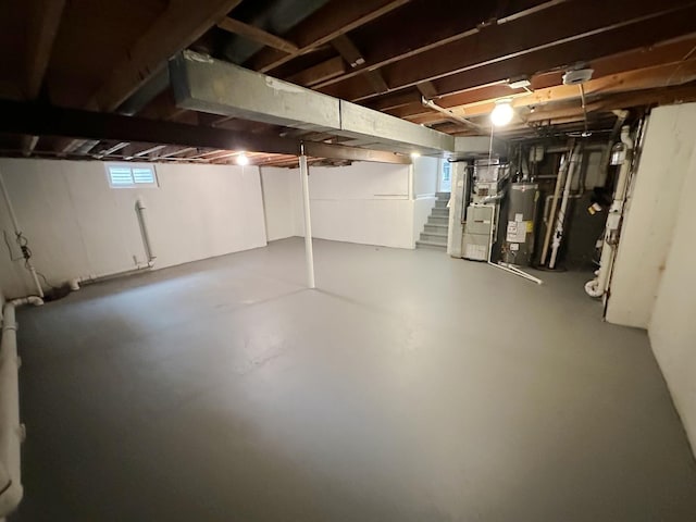 basement with heating unit, gas water heater, and a wealth of natural light