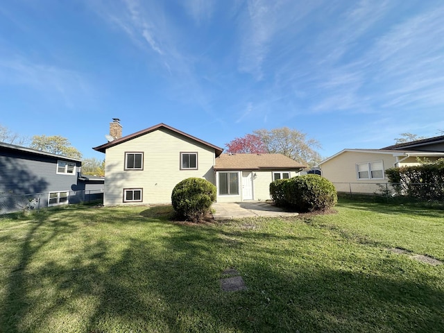 back of property featuring a lawn and a patio area