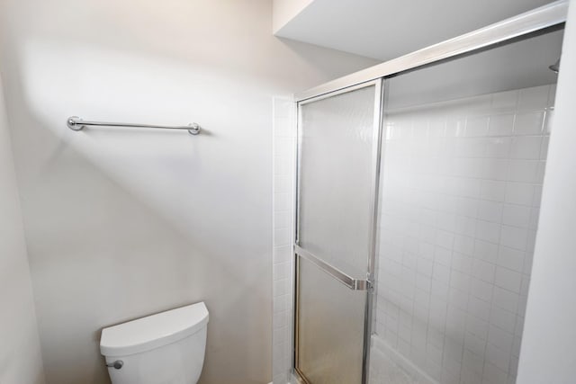 bathroom featuring toilet and walk in shower