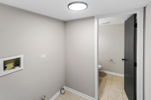 clothes washing area featuring hookup for a washing machine and light tile patterned floors