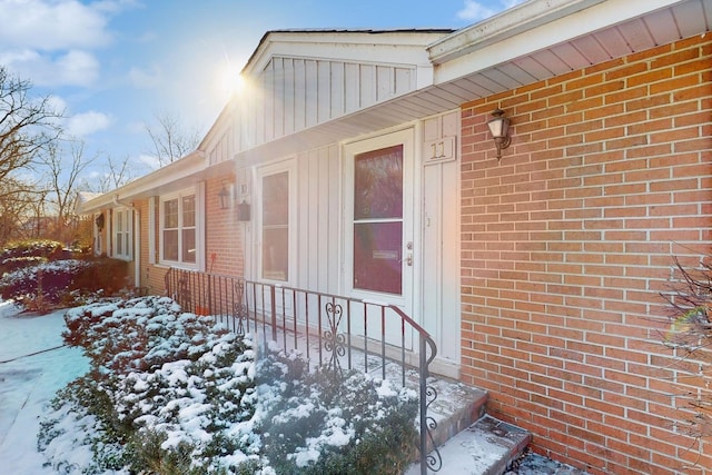 view of snow covered property entrance