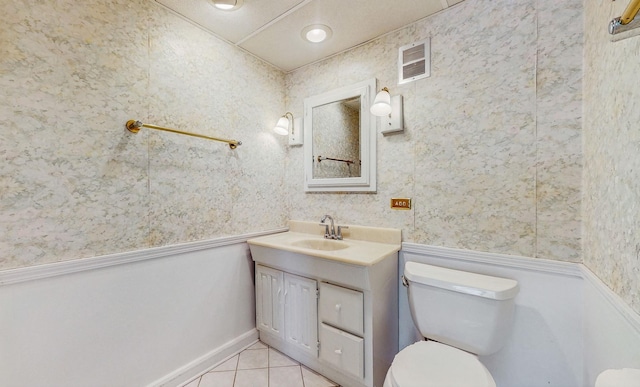 bathroom featuring toilet, tile patterned flooring, and vanity