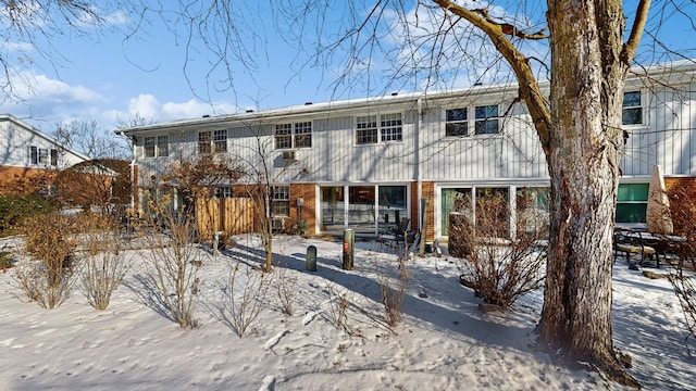 view of snow covered rear of property