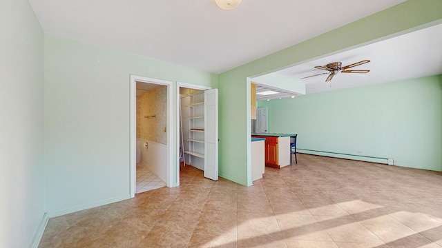 unfurnished room with baseboard heating, ceiling fan, and light tile patterned floors