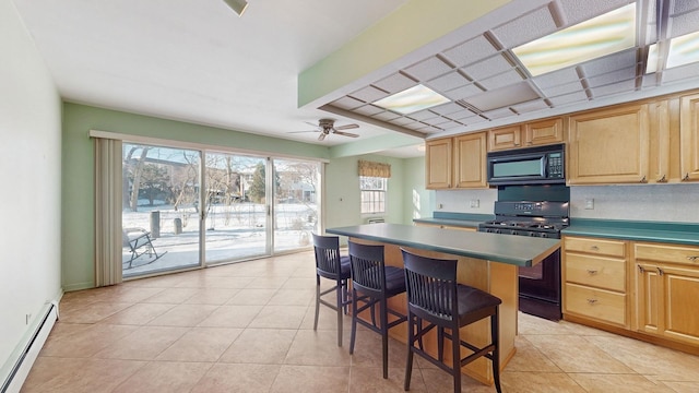 kitchen with light tile patterned flooring, black appliances, a kitchen island, a baseboard radiator, and a breakfast bar