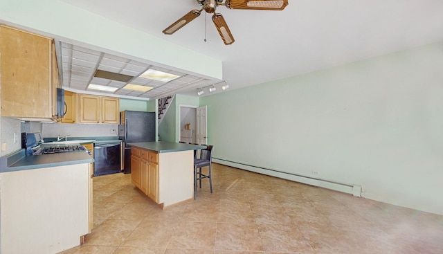 kitchen with black appliances, a kitchen bar, a kitchen island, baseboard heating, and ceiling fan