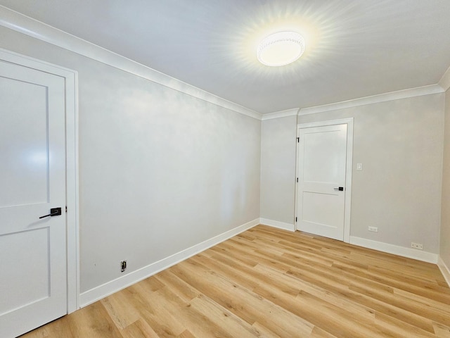 unfurnished room with light wood-type flooring and ornamental molding