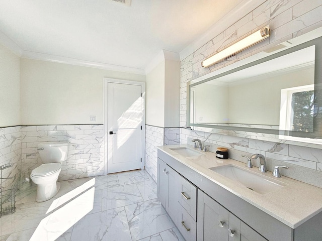 bathroom featuring toilet, vanity, tile walls, and ornamental molding