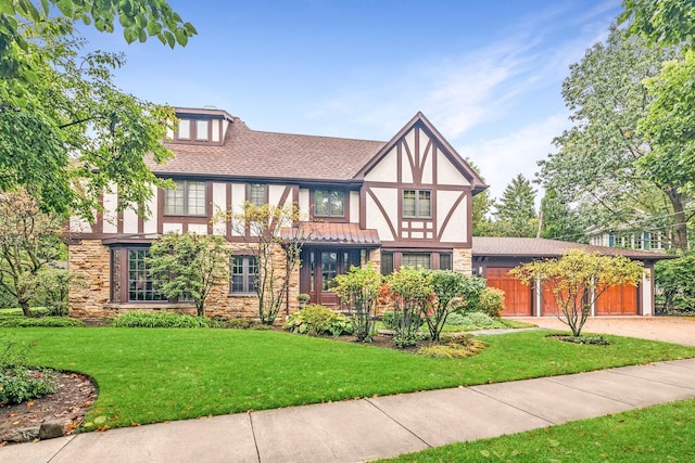 tudor house with a garage and a front yard