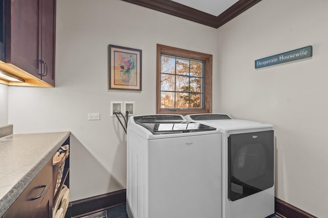 laundry area with washer and dryer, cabinets, dark tile patterned floors, and ornamental molding