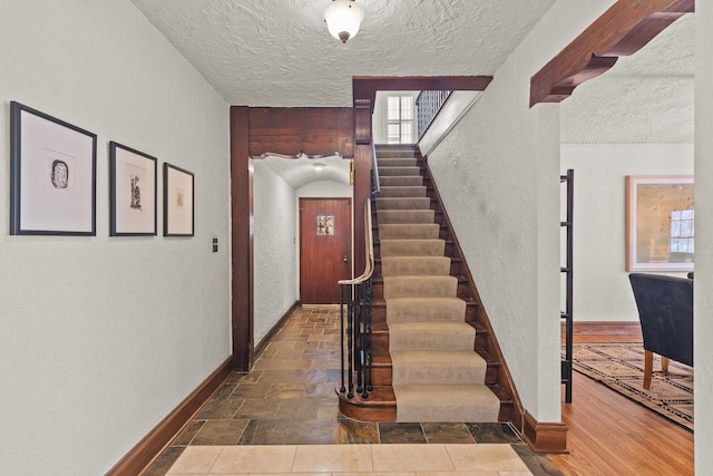 stairway with a textured ceiling