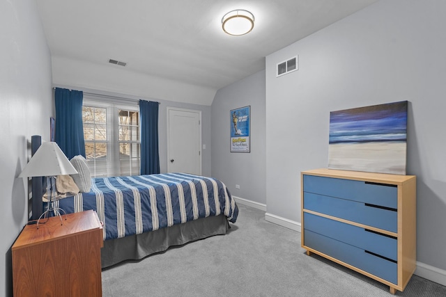 bedroom with light carpet and lofted ceiling