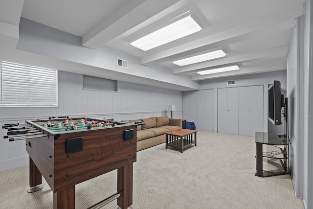 playroom with light colored carpet and beam ceiling