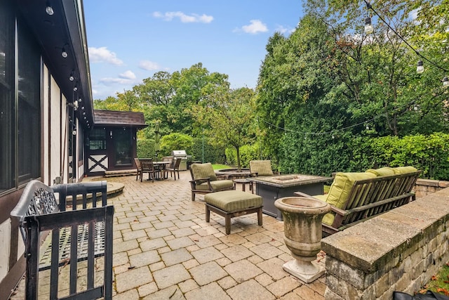 view of patio / terrace featuring an outdoor fire pit