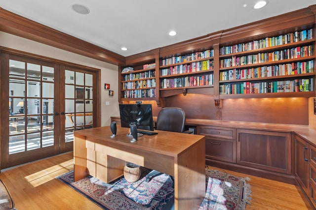 home office featuring ornamental molding, french doors, and light hardwood / wood-style flooring