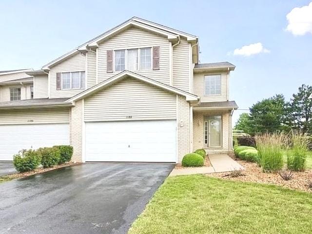 view of front property featuring a garage and a front lawn