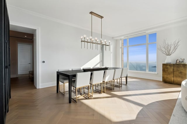 dining area with parquet flooring, crown molding, and an inviting chandelier