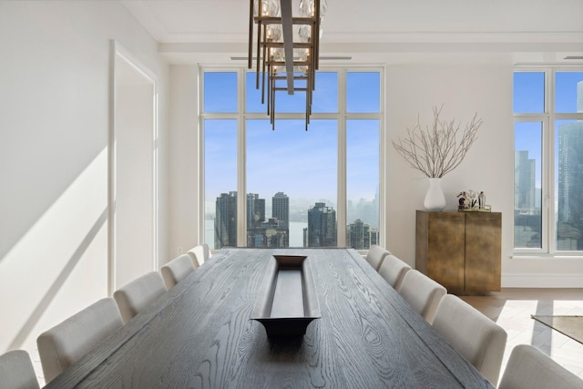 dining space featuring ornamental molding and an inviting chandelier