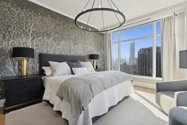 bedroom with multiple windows, crown molding, and hardwood / wood-style flooring