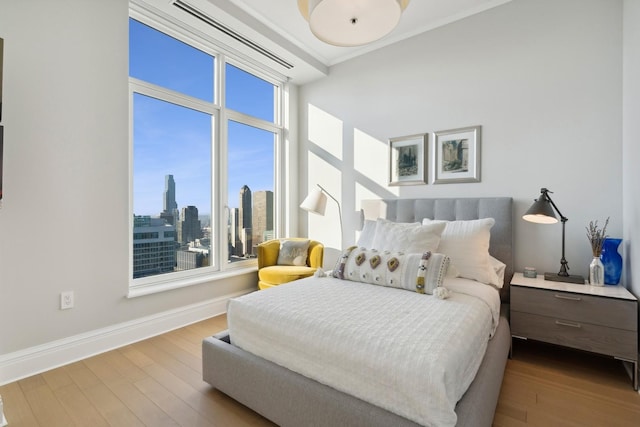 bedroom featuring light hardwood / wood-style floors and ornamental molding