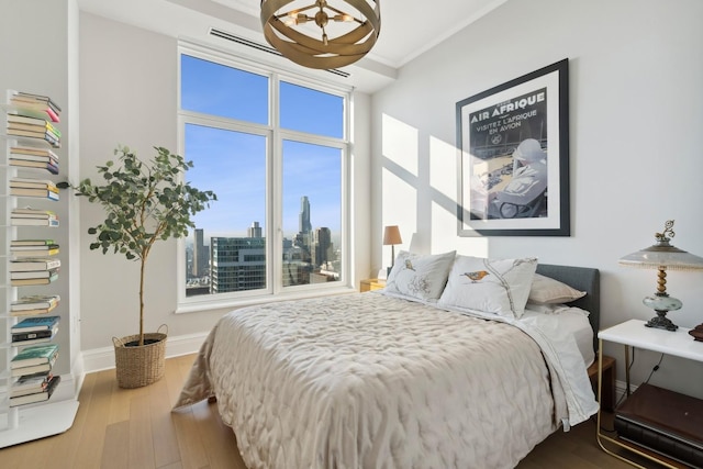 bedroom featuring hardwood / wood-style flooring and multiple windows