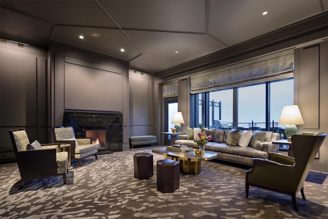 living room with carpet, crown molding, and a premium fireplace