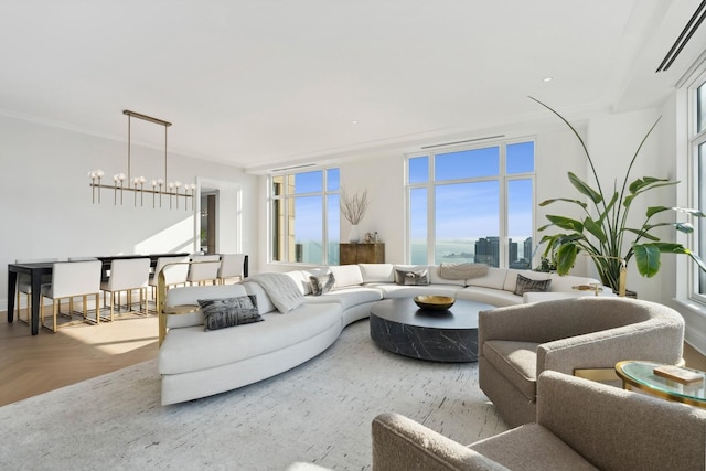 living room with crown molding, a chandelier, and parquet flooring