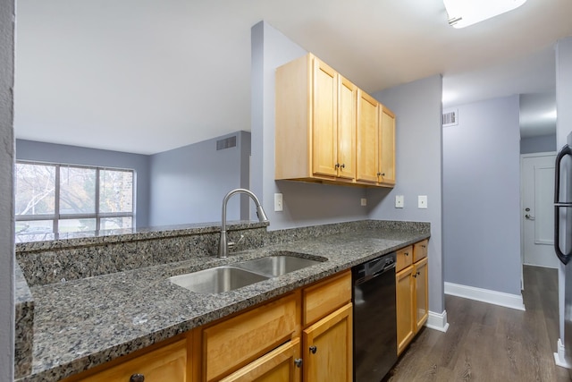 kitchen with dishwasher, dark hardwood / wood-style floors, dark stone counters, and sink